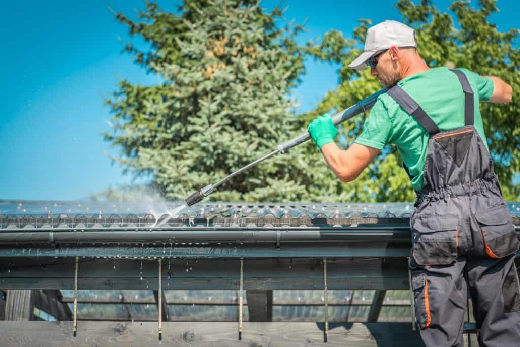 man cleaning gutter